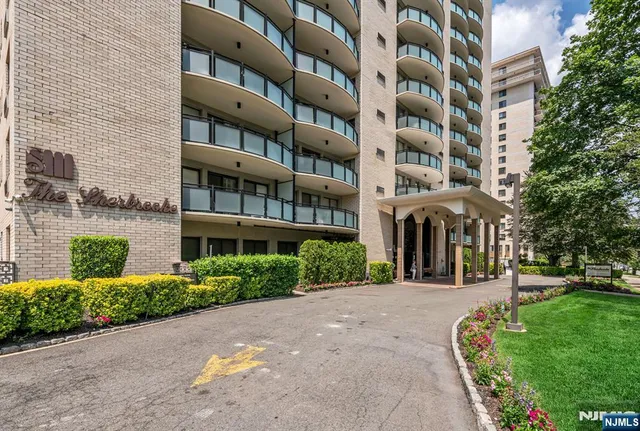 a front view of a multi story building with yard