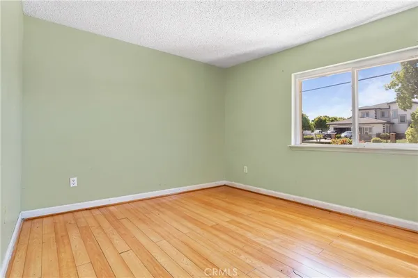 a view of a room with wooden floor and fan
