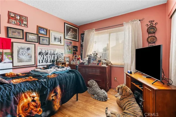 a bedroom with furniture and a flat screen tv