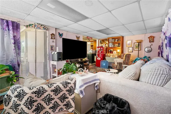 a bedroom with bed and a flat tv screen