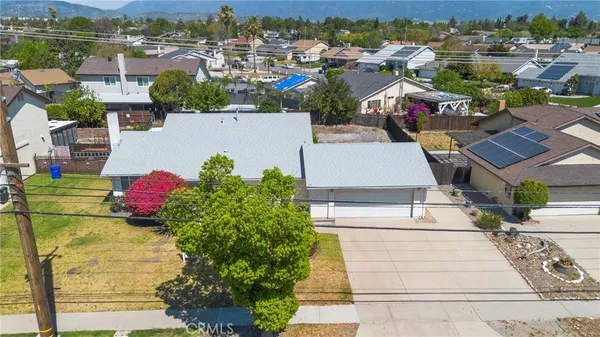 an aerial view of a houses with yard