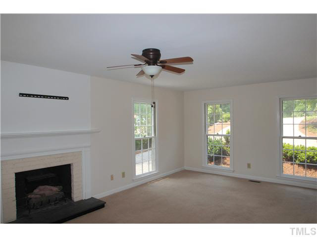 305 Southwest Maynard Road Cary, NC 27511 - Photo 4 of 15 Large family room with fireplace and ceiling fan