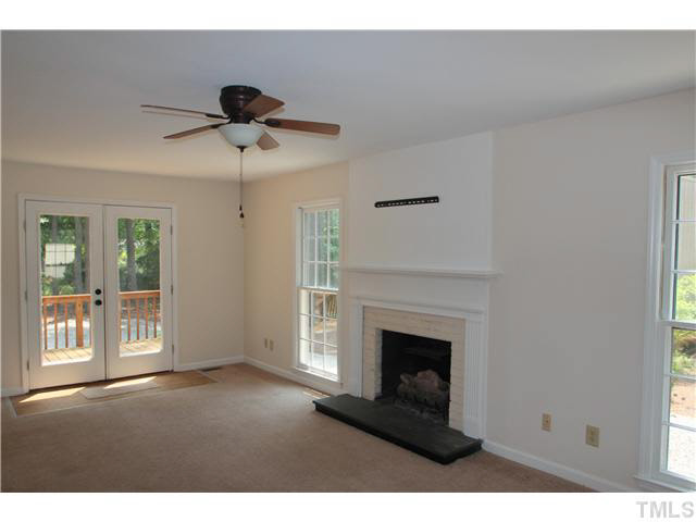 305 Southwest Maynard Road Cary, NC 27511 - Photo 5 of 15 Large family room with fireplace and ceiling fan