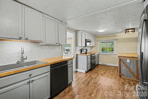 a kitchen with a refrigerator sink and cabinets