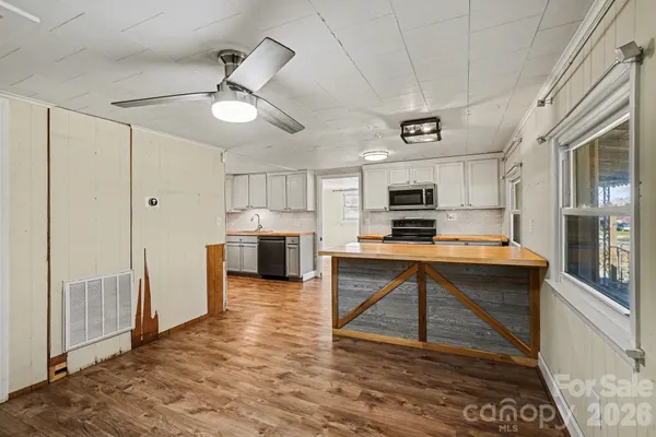 a view of a kitchen with microwave and cabinets