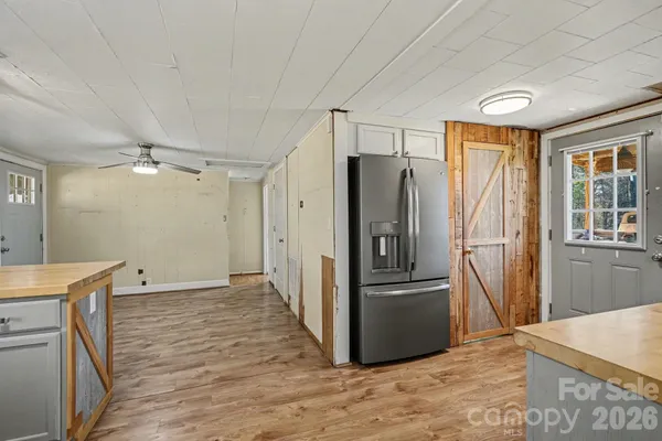 a view of a refrigerator in kitchen and wooden floor