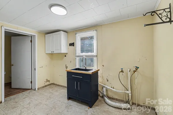 a view of a kitchen with a sink cabinets and a window