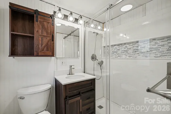 a bathroom with a sink toilet and shower