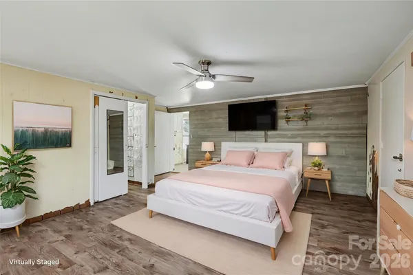 a bedroom with a large bed and a flat screen tv