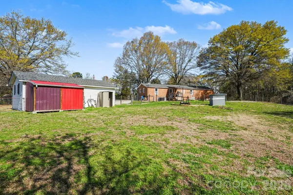 a view of a house with a backyard