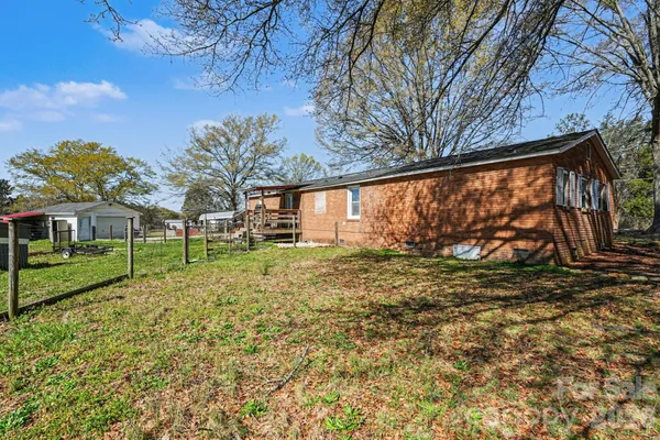 a view of a backyard with large trees