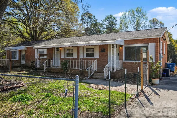 a view of a house with backyard porch and sitting area