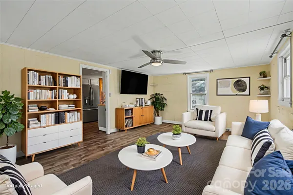 a living room with furniture a rug and a flat screen tv