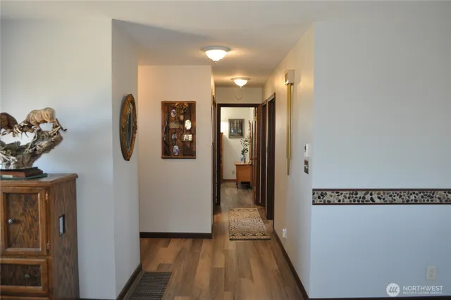 a view of hallway with wooden floor