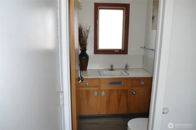 a bathroom with a sink toilet and mirror