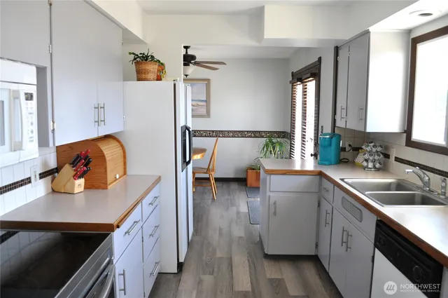 a kitchen with sink refrigerator and window