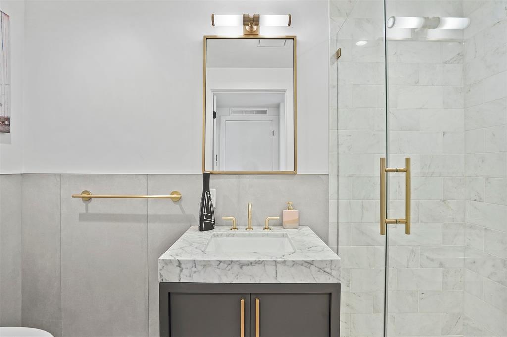 70 Rainey Street, Unit 1409 Austin, TX 78701 - Photo 20 of 38 Bathroom with vanity and a marble finish shower