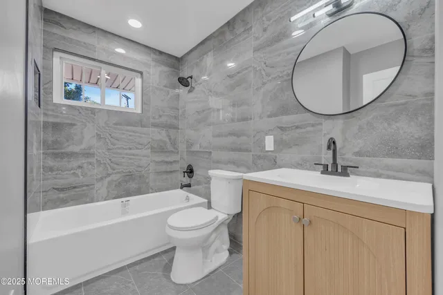 a bathroom with a sink a mirror and a toilet