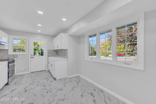 a view of a kitchen with furniture and windows