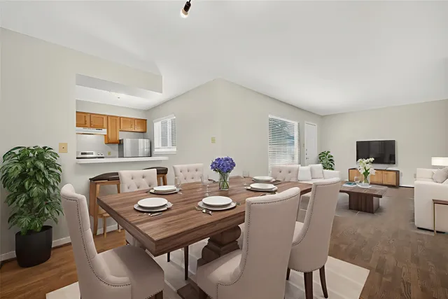 a view of a dining room with furniture and wooden floor