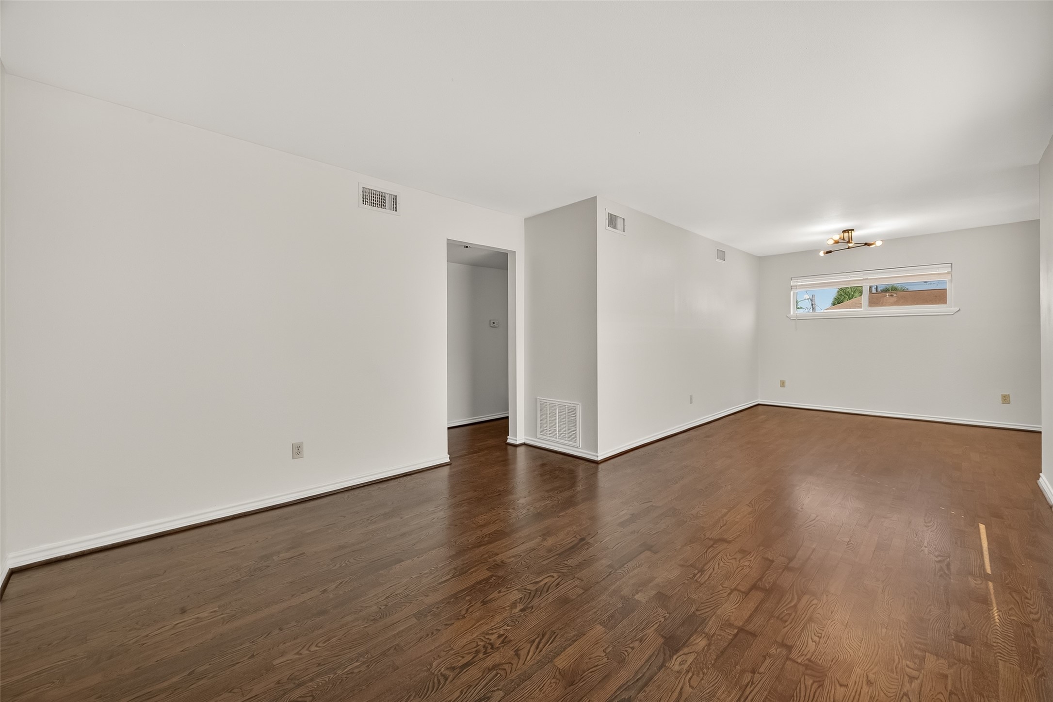 2020 Huldy Street, Unit 10 Houston, TX 77019 - Photo 11 of 24 an empty room with wooden floor & windows