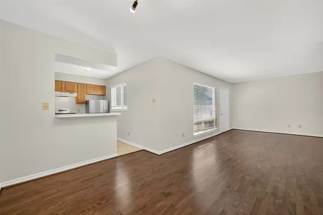 a kitchen with a refrigerator sink and cabinets