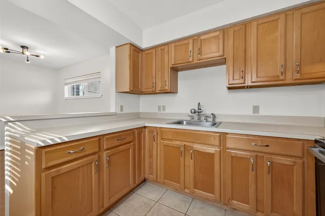a view of a kitchen with white cabinets