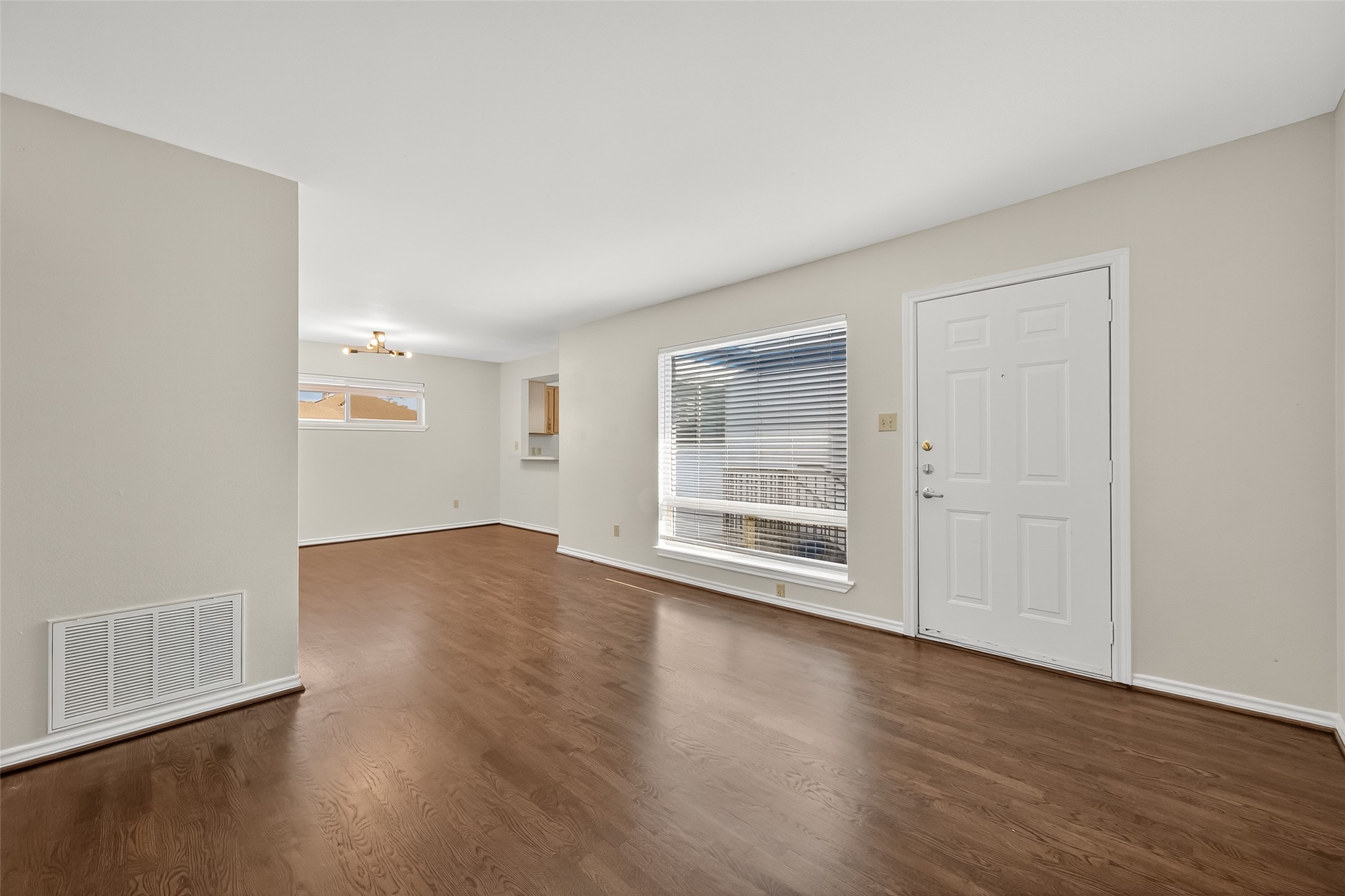 2020 Huldy Street, Unit 10 Houston, TX 77019 - Photo 8 of 24 an empty room with wooden floor and windows