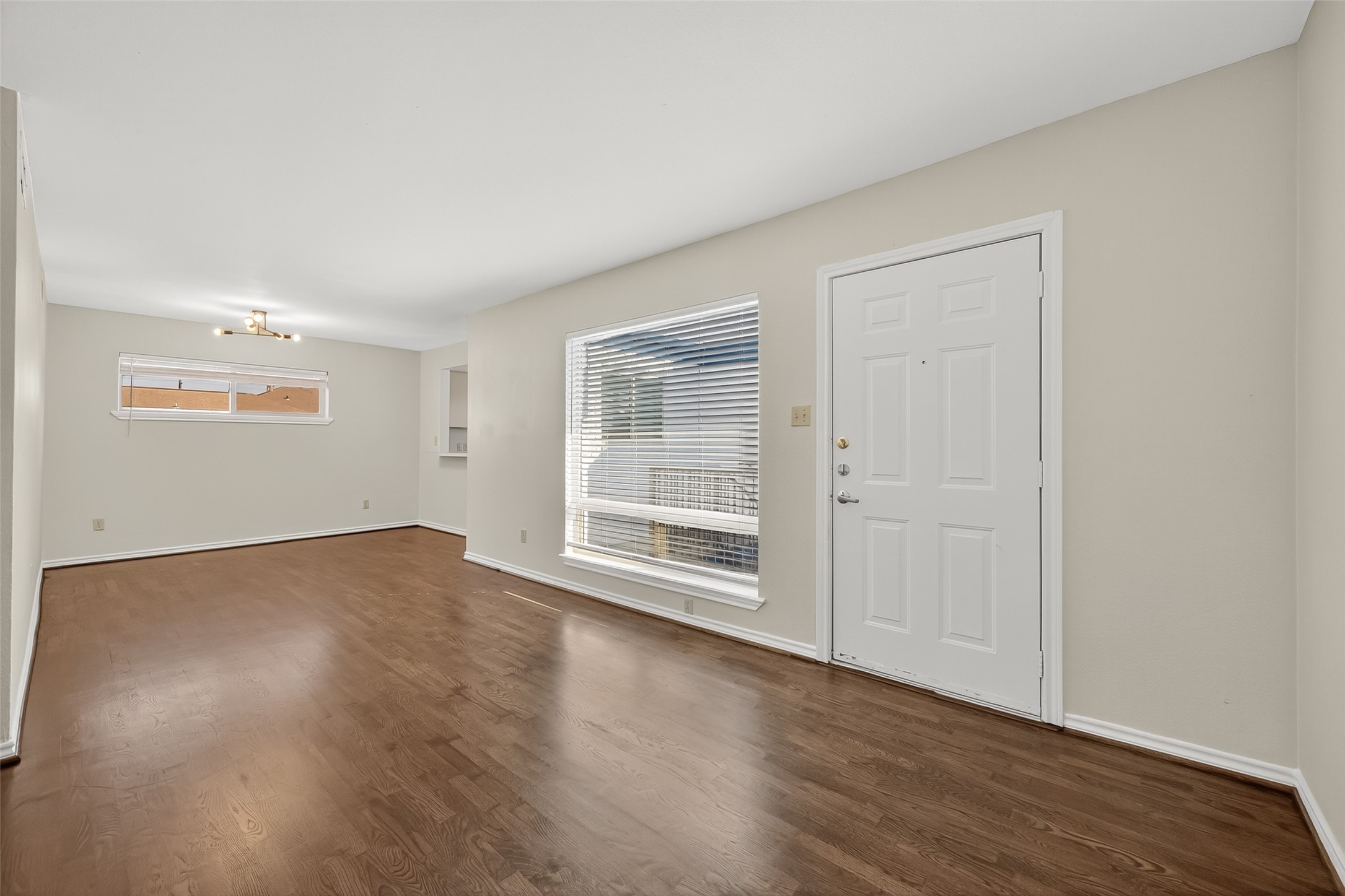 2020 Huldy Street, Unit 10 Houston, TX 77019 - Photo 9 of 24 an empty room with wooden floor and windows