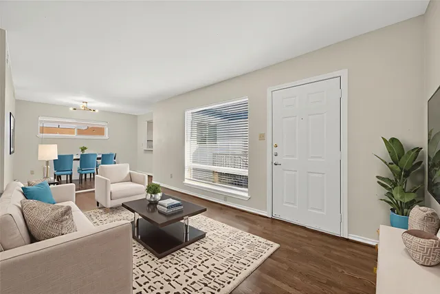 an empty room with wooden floor & windows