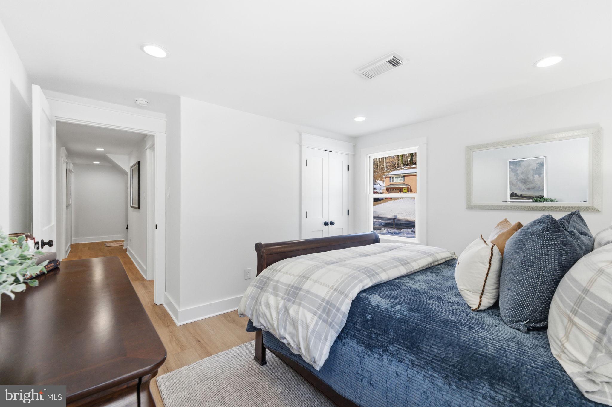 8615 Kerry Lane Springfield, VA 22152 - Photo 35 of 50 a spacious bedroom with a bed and a couch