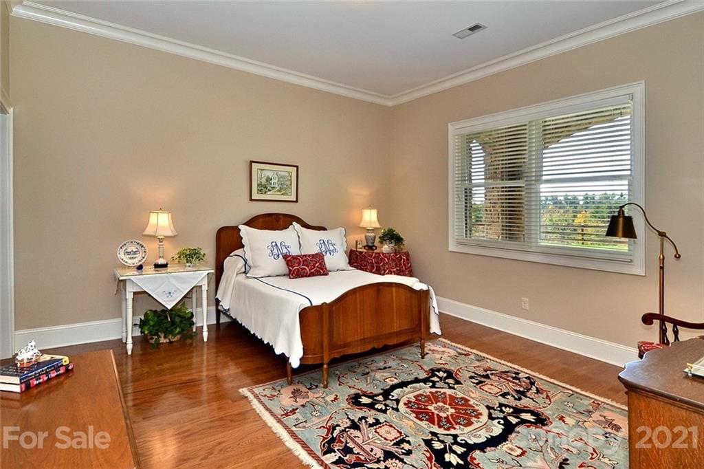 352 Windflower Ln Mill Spring Tryon, NC 28782 - Photo 14 of 43 a bedroom with a bed and wooden floor