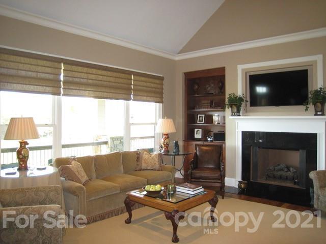 352 Windflower Ln Mill Spring Tryon, NC 28782 - Photo 18 of 43 a living room with furniture a flat screen tv and a fireplace