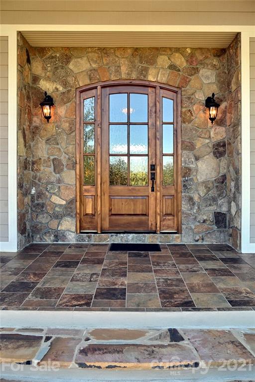 352 Windflower Ln Mill Spring Tryon, NC 28782 - Photo 3 of 43 a view of a entryway door of the house