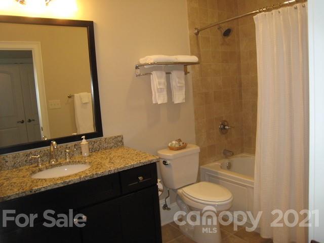 352 Windflower Ln Mill Spring Tryon, NC 28782 - Photo 24 of 43 a bathroom with a granite countertop sink toilet and shower