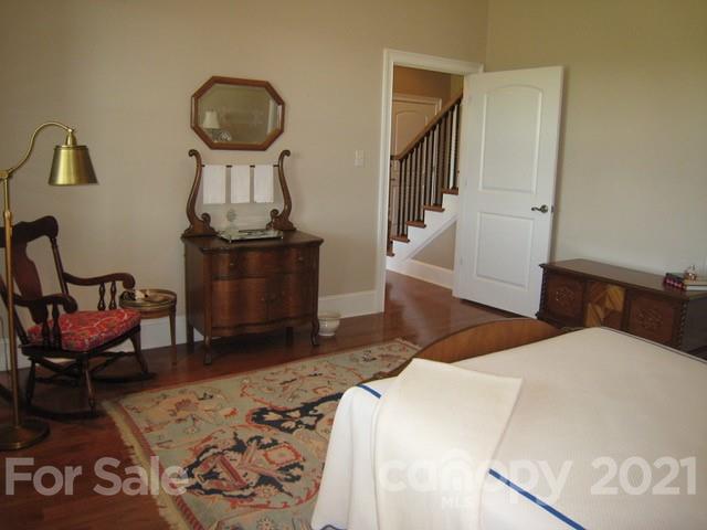 352 Windflower Ln Mill Spring Tryon, NC 28782 - Photo 27 of 43 a bedroom with bed and wooden floor