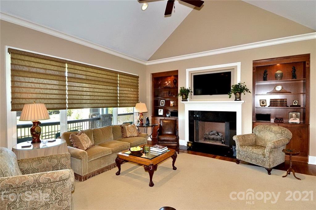 352 Windflower Ln Mill Spring Tryon, NC 28782 - Photo 5 of 43 a living room with furniture a fireplace and a flat screen tv