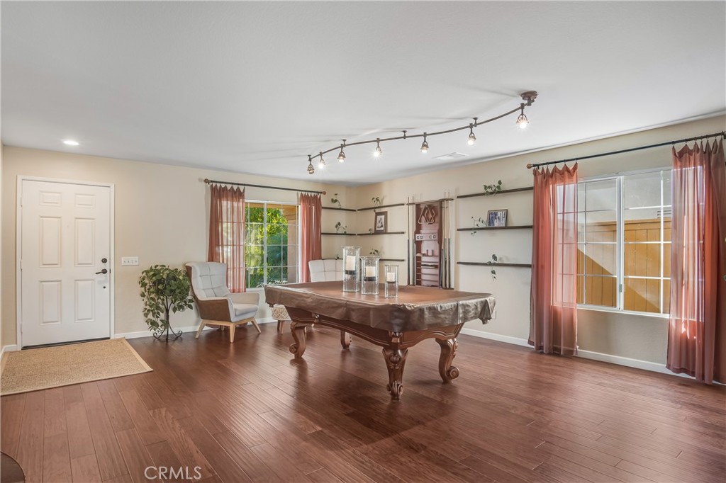 4330 Forest Ranch Way Oceanside, CA 92057 - Photo 8 of 51 The living room is wrapped in an abundance of windows, flooding the space with natural light and creating an airy, inviting atmosphere that instantly feels like home.