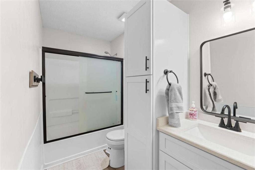 1220 South Hampton Road Hampton, GA 30228 - Photo 14 of 30 a bathroom with a sink a toilet and shower