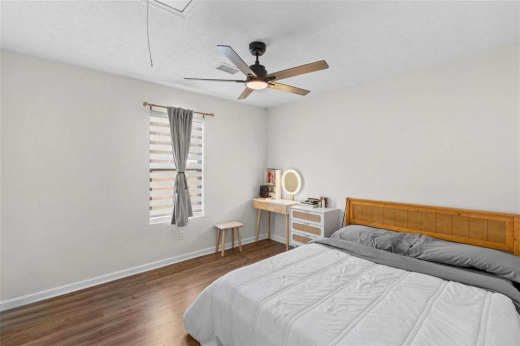 1220 South Hampton Road Hampton, GA 30228 - Photo 15 of 30 a bedroom with a bed and a window