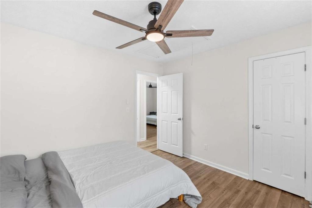 1220 South Hampton Road Hampton, GA 30228 - Photo 16 of 30 a bedroom with a bed and a ceiling fan