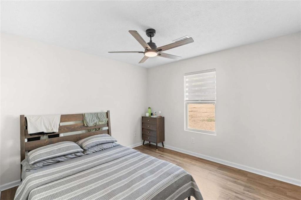 1220 South Hampton Road Hampton, GA 30228 - Photo 17 of 30 a bedroom with a bed and a window