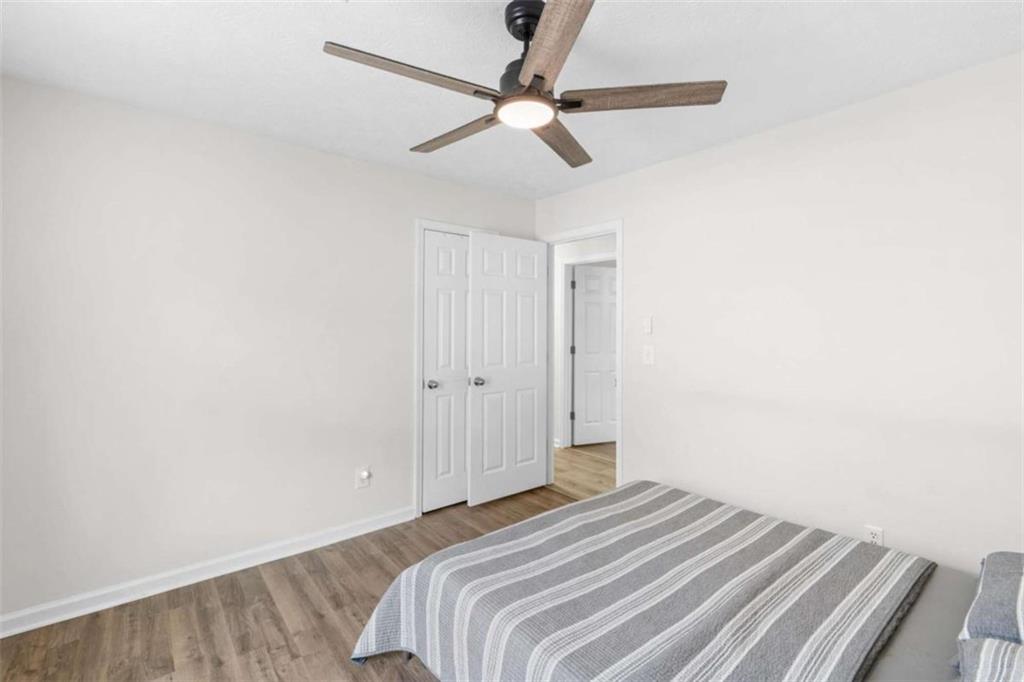 1220 South Hampton Road Hampton, GA 30228 - Photo 18 of 30 a bedroom with a bed and a ceiling fan