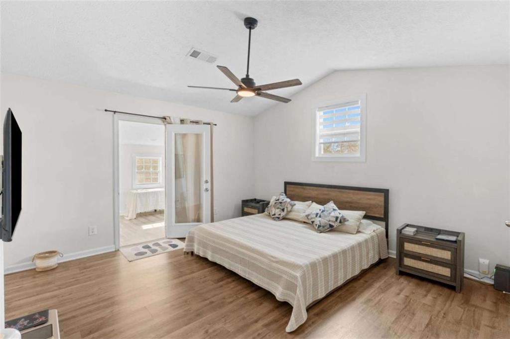 1220 South Hampton Road Hampton, GA 30228 - Photo 19 of 30 a bedroom with a bed and a ceiling fan