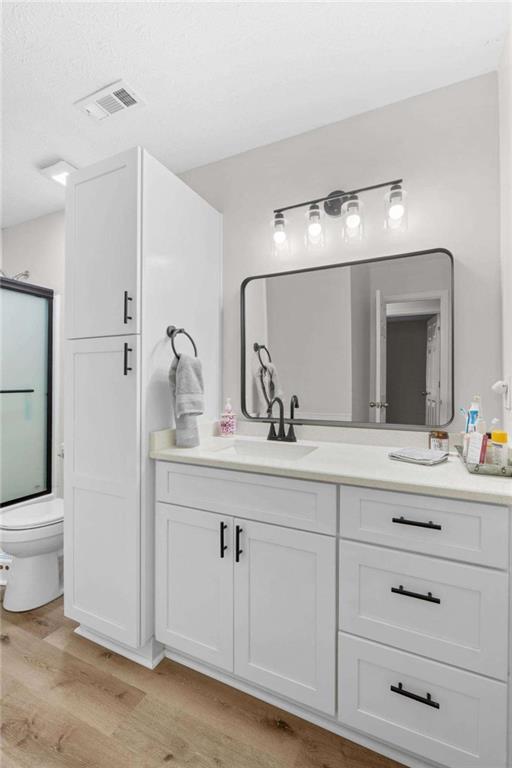 1220 South Hampton Road Hampton, GA 30228 - Photo 22 of 30 a bathroom with a toilet a sink and mirror
