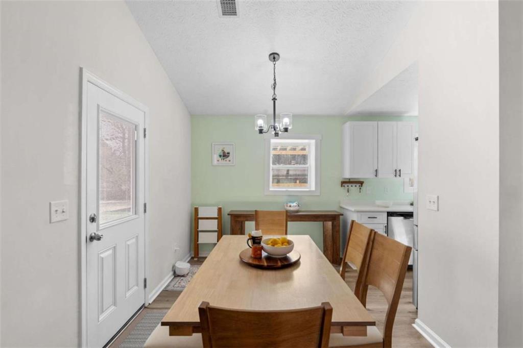 1220 South Hampton Road Hampton, GA 30228 - Photo 8 of 30 a view of a dining room with furniture window and wooden floor