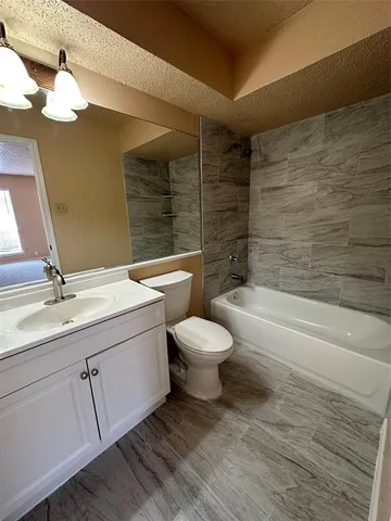 a bathroom with a toilet and a bath tub