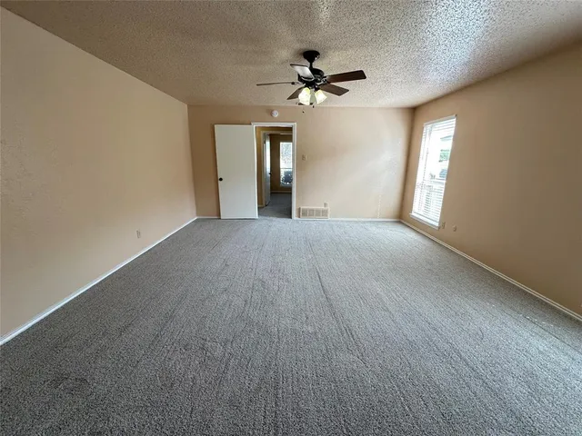 a view of an empty room with a fireplace