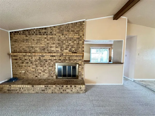 a view of a backyard with large trees and wooden fence