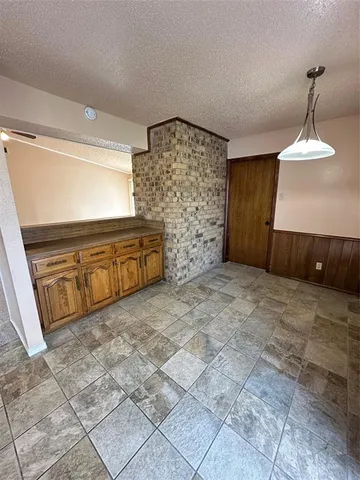 a view of a livingroom with wooden cabinets